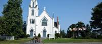 Cycling along a peaceful road, discovering a historic church tucked away in the landscape | Nathalie Gauthier